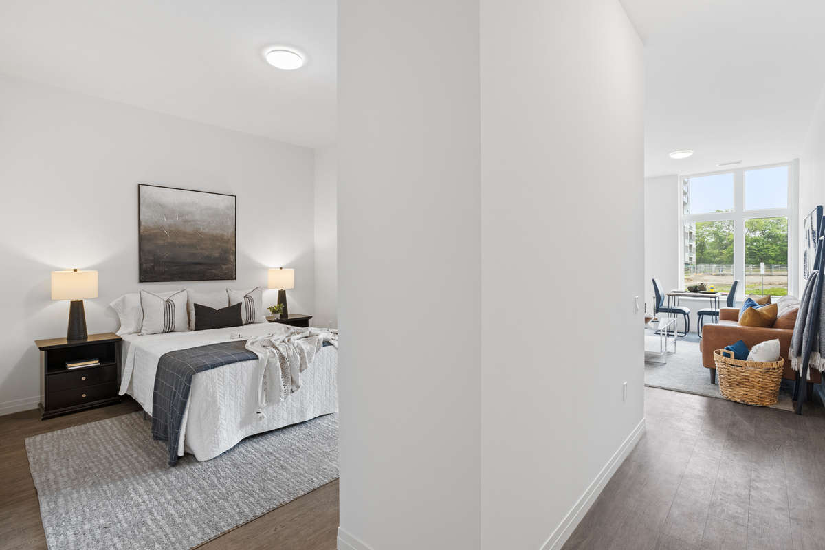 Another view of the open concept apartment, a view into bedroom, hall and living room. Photo of a one-bedroom model suite apartment at Zerin Place on South Street at 370 South St. in London Ontario. A housing project by Zerin Development in VillageSoHo.